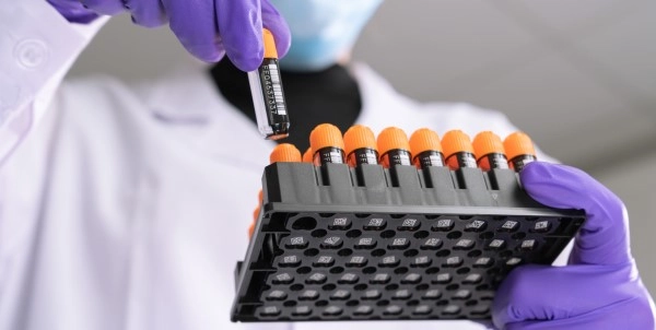 Researcher holding FluidX Tubes