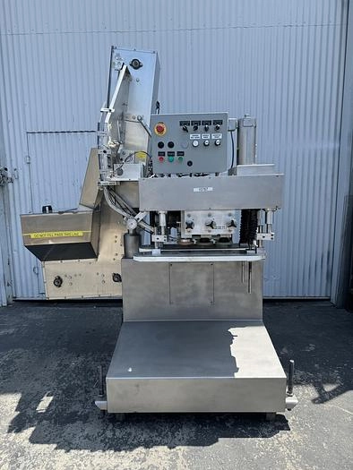 Six Spindle Capper with attached Cap Elevator