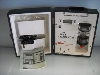 THE BUCK CALIBRATOR A PRIMARY GAS FLOW STANDARD 31159 COMES WITH BLACK CASE CORD AND INSTRUCTION MAN