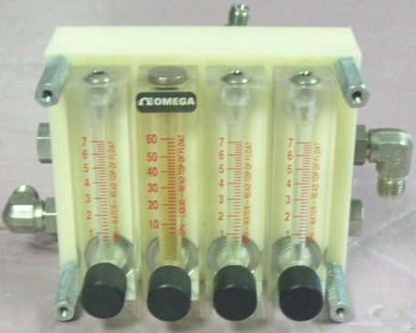 A BLOCK WITH 4 OMEGA LIQUID/WATER FLOW METERS 3 READ 1 TO 7 GPH WATER 1 READS 10 TO 60 GPH LIQUID