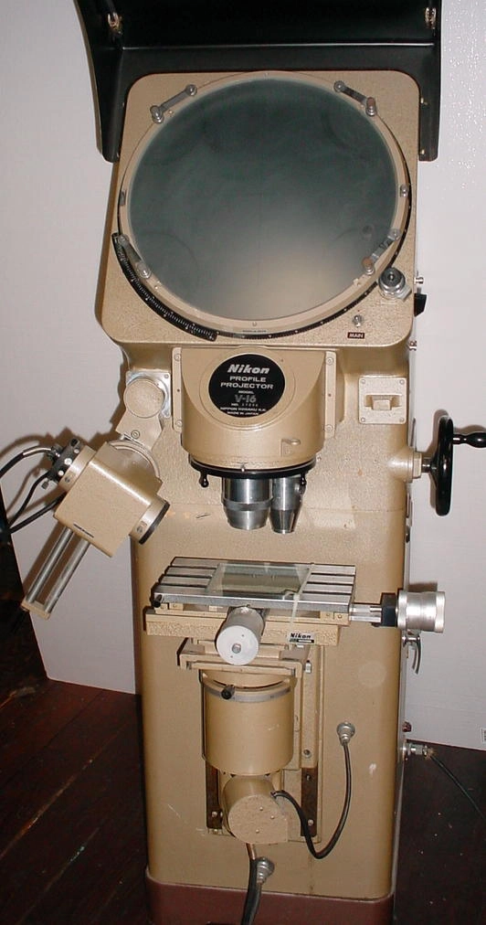 Nikon V-16 Optical comparator, 16" diameter protractor screen, 10 and 20 power lenses, 2 x 4 inch micrometer state, contour and surface illumination, 115 volts.