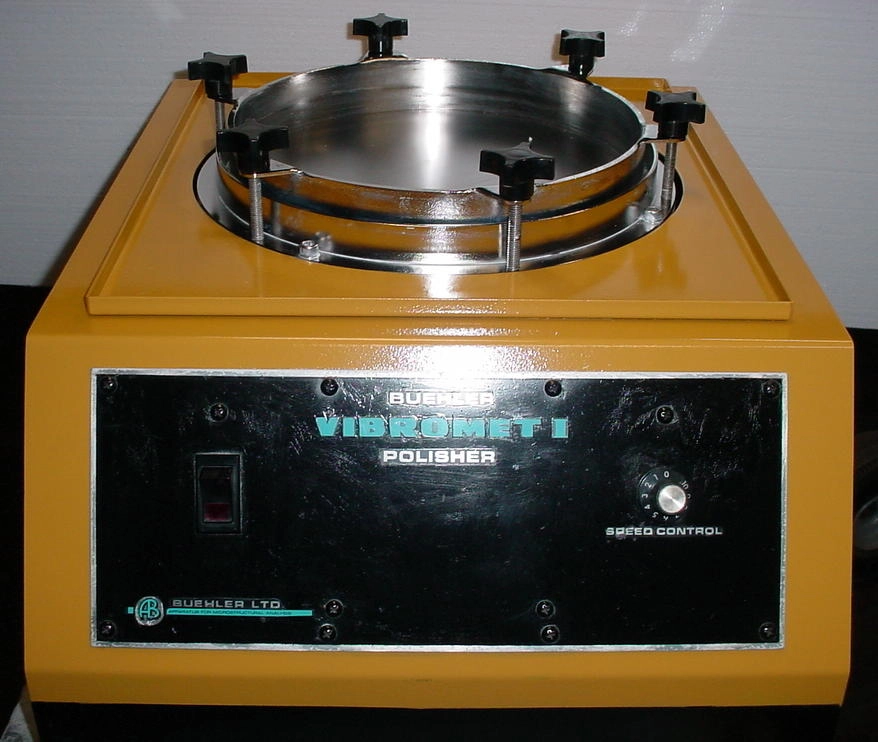 Buehler VibrometI polisher. With three 1.25" holder/weights. Plastic cover cracked. 115 volts, approx 175#