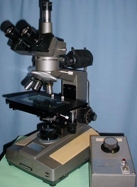 Olympus BHC, relfected and transmitted light, 15 watt, with trinocular head, 10 power eyepieces, MPlan 5, 10, 20, 40 and 100 power objectives. 2 x 3 " travel stage