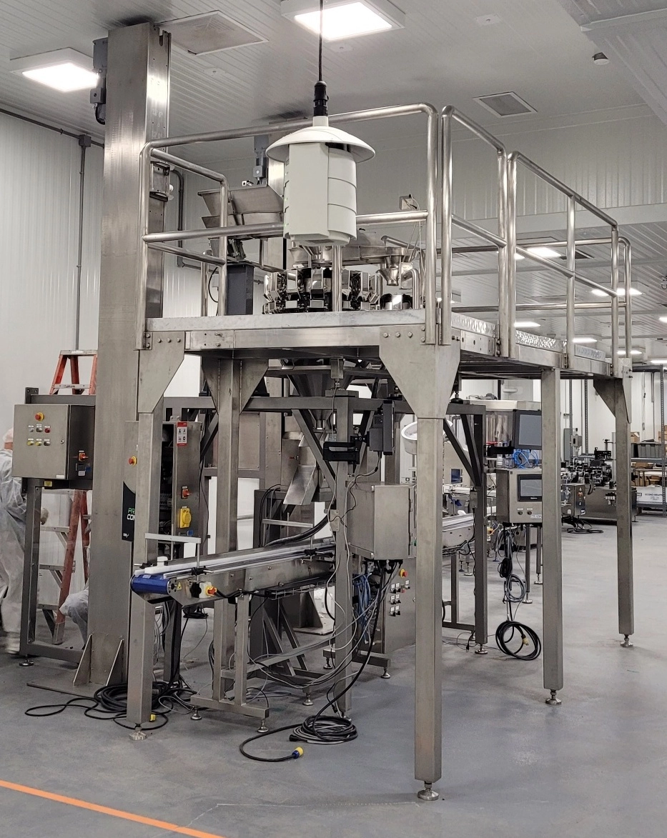 Used WeighPack High Speed Double Container Filler with Two PrimoCombi 14 Head 0.5L Multi-Scale Weigher Systems will fill two containers simultaneously.