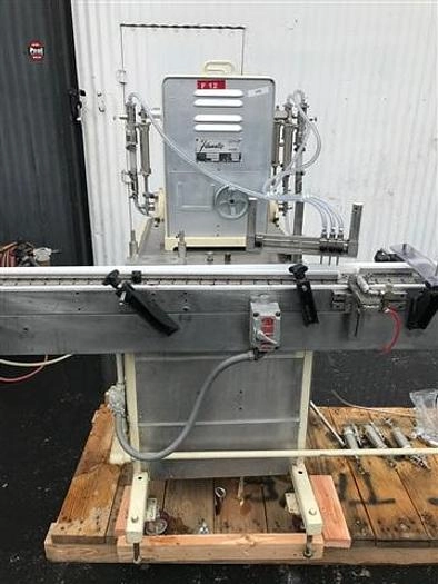 Filamatic Four Head Piston Filler With Conveyor